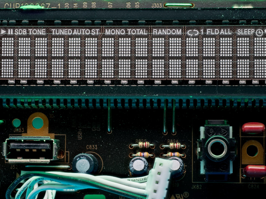 A close-up of a laptop motherboard with various ports and chips visible