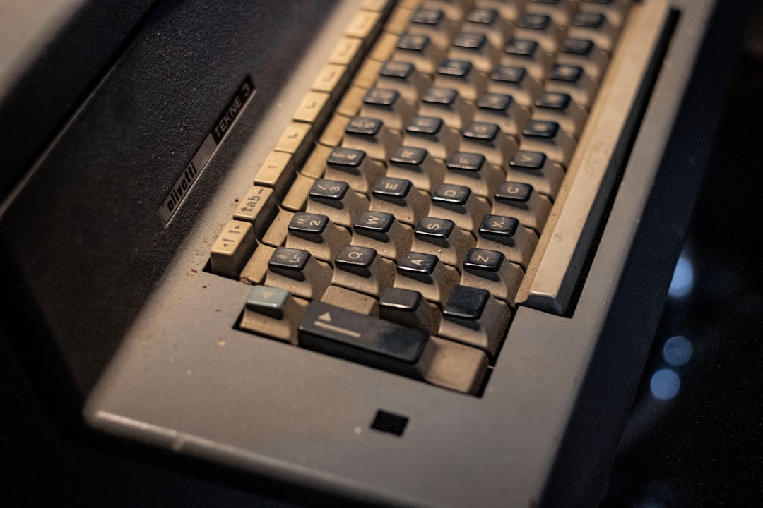 A person typing on a classic ThinkPad keyboard with a red TrackPoint